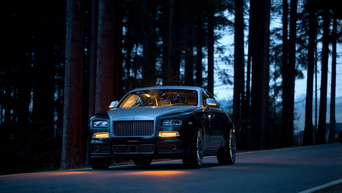 Rolls Royce car on a road at dusk