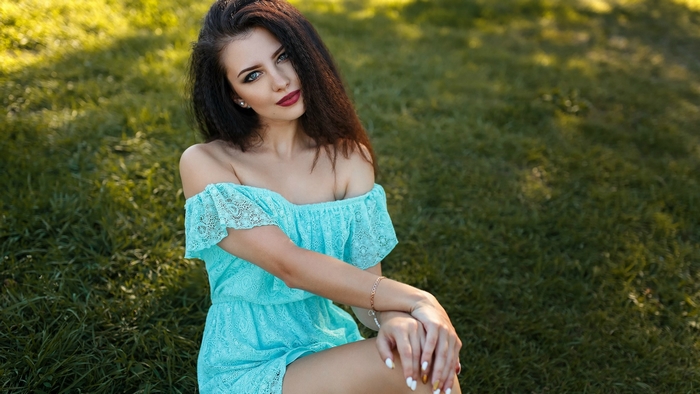 Brunette model in a blue dress outdoors