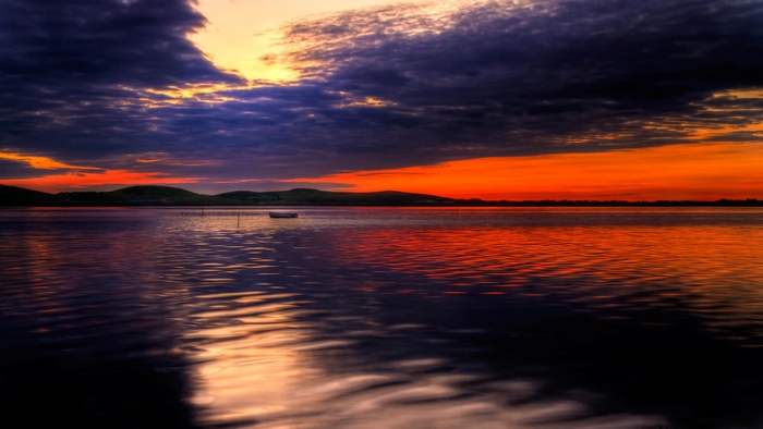 Vibrant Orange Sunset Over Calm Lake