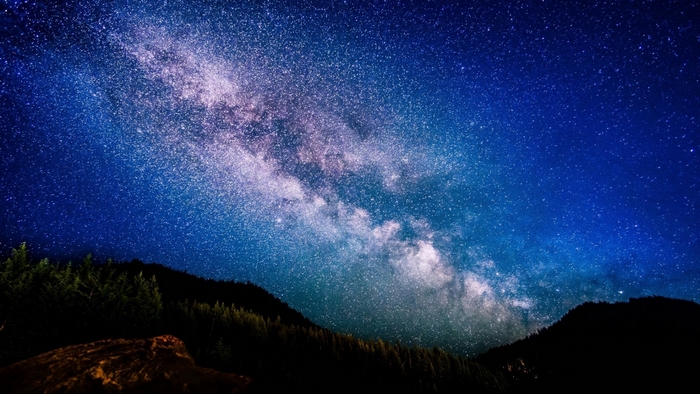 Milky Way galaxy over mountains at night