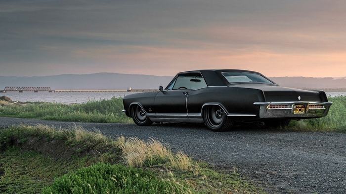 1965 Buick Riviera parked by a body of water