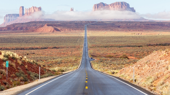 Long Straight Road Through Desert Landscape