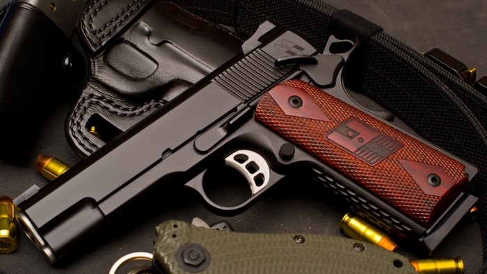 Nighthawk Custom 1911 pistol with ammunition and holster