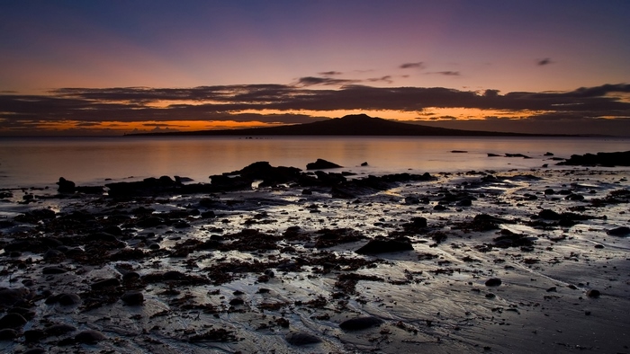 Beach sunset with island silhouette