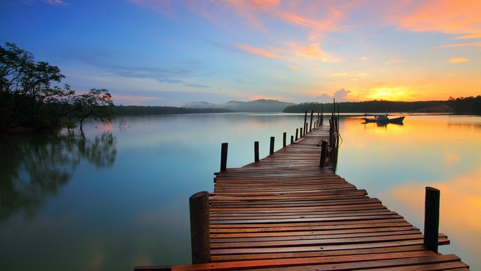Wooden pier on a lake at sunset
