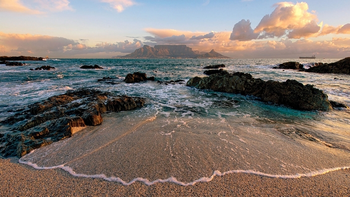 Table Mountain and ocean waves at sunset