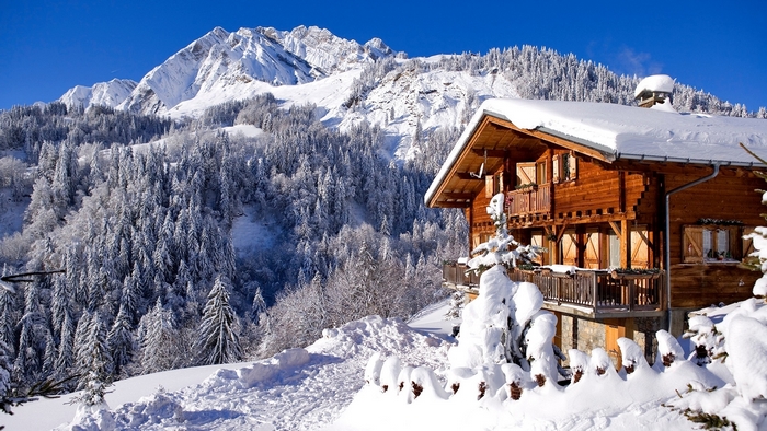 Wooden chalet in snowy mountains