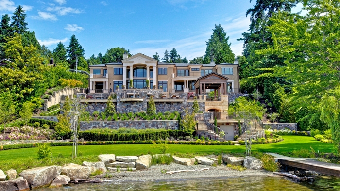 Luxurious modern mansion on a hillside overlooking water