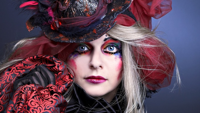 Woman with elaborate makeup and hat