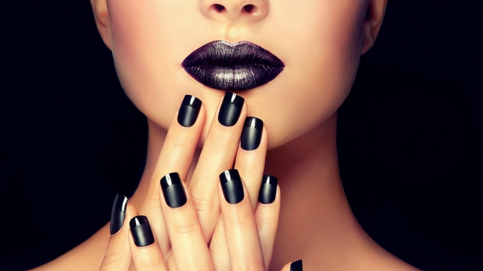 Woman with black lipstick and nails
