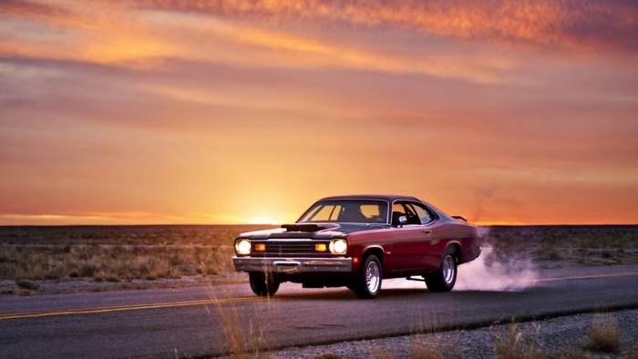 Plymouth Duster Car Driving at Sunset