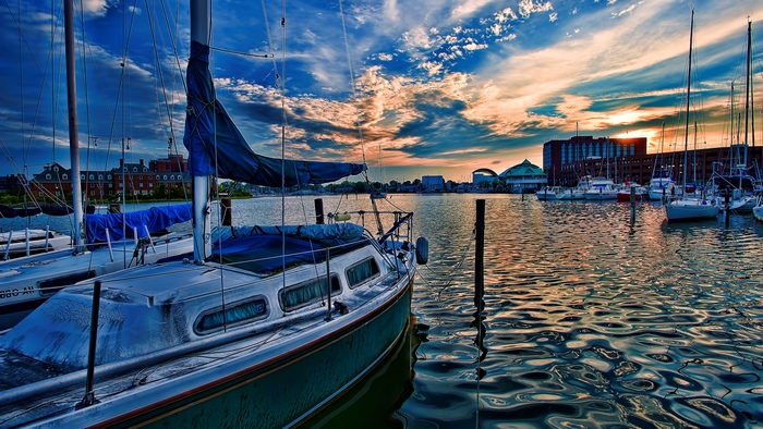 Sailboats Docked at a Tranquil Waterfront at Sunset