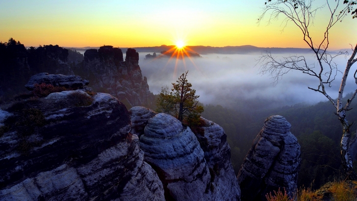 Sunrise Over Foggy Rocky Mountain Landscape