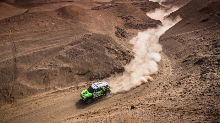 Green Mini Cooper rally car in desert
