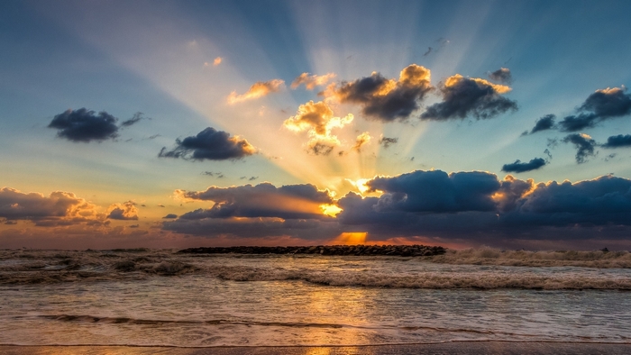 Sunset over the sea with crepuscular rays