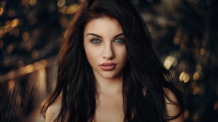 Woman with dark hair and blue eyes