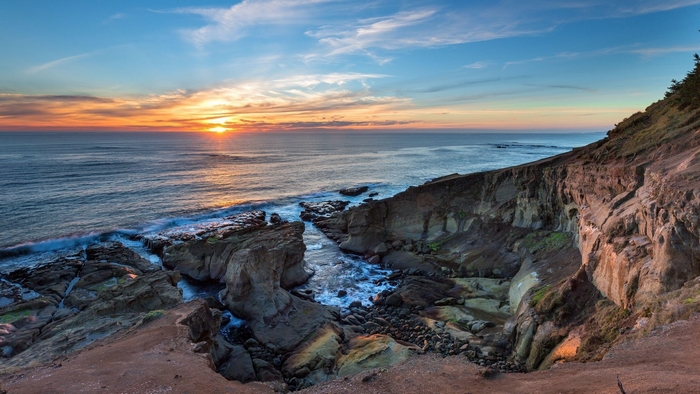 Sunset over the rocky coast and ocean