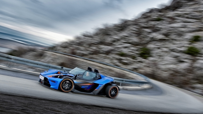 Blue KTM X-Bow R driving on a mountain road