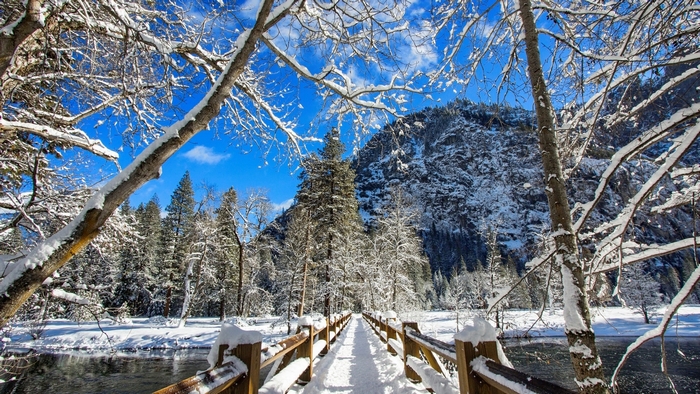 Snowy bridge over river in Yosemite National Park