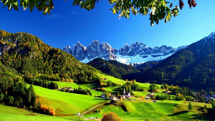 Green hills and snow-capped mountains in Italy