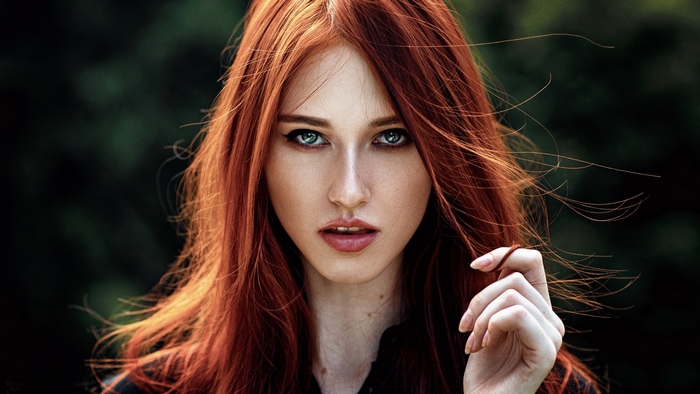 Woman with long red hair and blue eyes