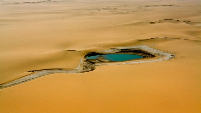 Desert landscape with a turquoise oasis