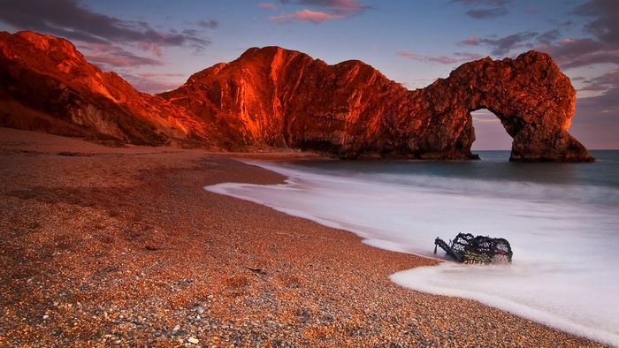 Durdle Door rock arch at sunset with lobster pot