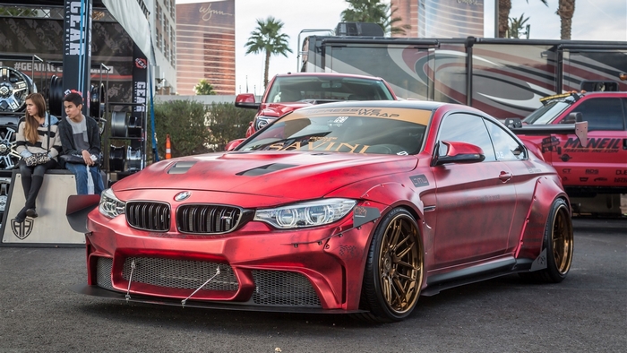 Custom red BMW M4 widebody with gold wheels