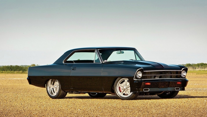 Black Chevrolet Nova muscle car on gravel lot