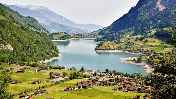 Lake and village nestled in a mountain valley