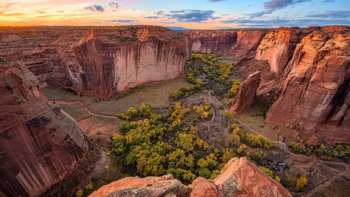 Canyon with trees and sunset sky