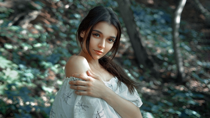Woman in a white dress in a forest
