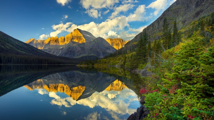 Sunlit Mountain Reflection on Calm Lake
