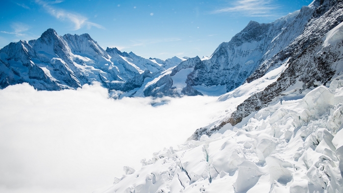 Snowy mountains in the Bernese Alps above clouds