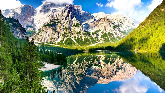 Lake Braies reflection of mountains and forest in Italy