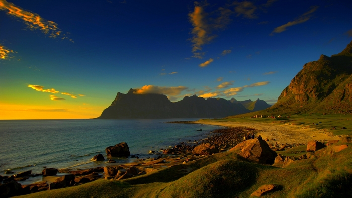 Rocky beach and mountains at sunset