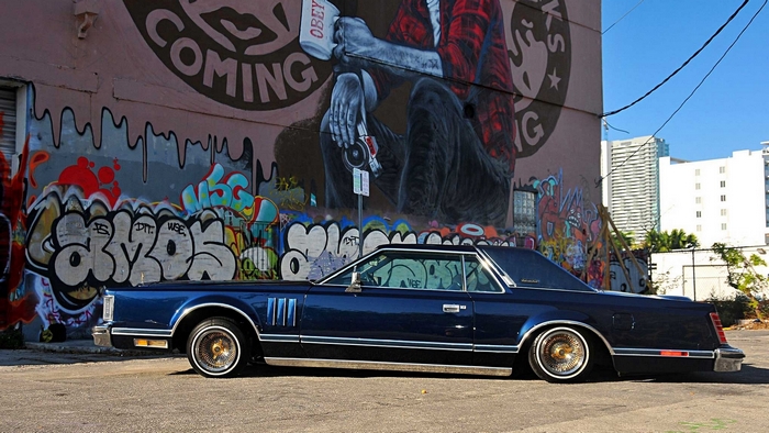 Blue 1979 Lincoln Continental Mark V lowrider with graffiti mural