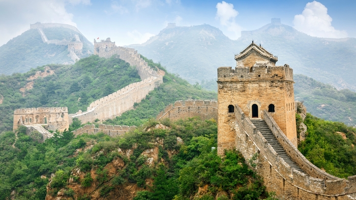 The Great Wall of China winding through misty mountains