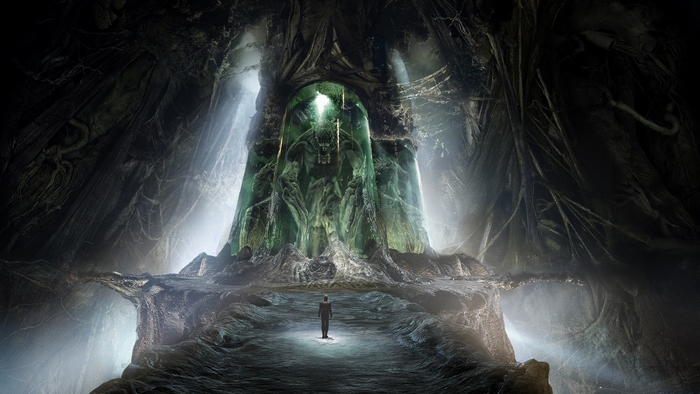 Fantasy creature in a glowing green pod in a dark cave
