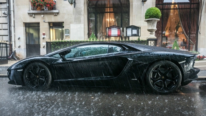 Black Lamborghini Aventador in the rain