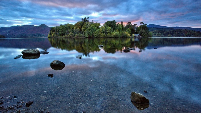 Island reflection on a lake at sunset