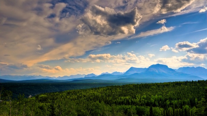Mountains and forests under a cloudy sky
