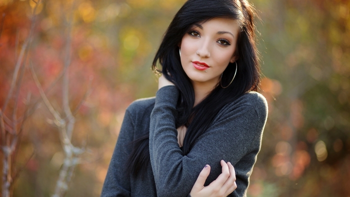 Woman with dark hair and hoop earrings