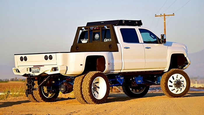 White 2016 GMC Lifted Truck on Dirt Road