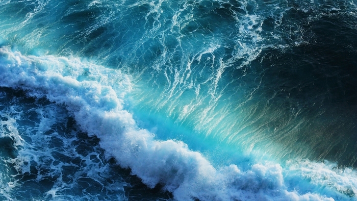 Ocean waves with white foam and blue water