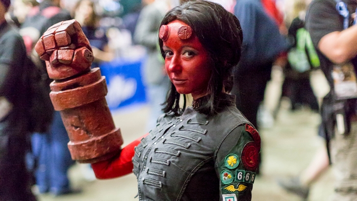 Woman dressed as Hellboy with large red fist