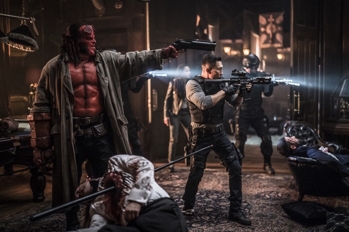 Hellboy and soldiers in a room