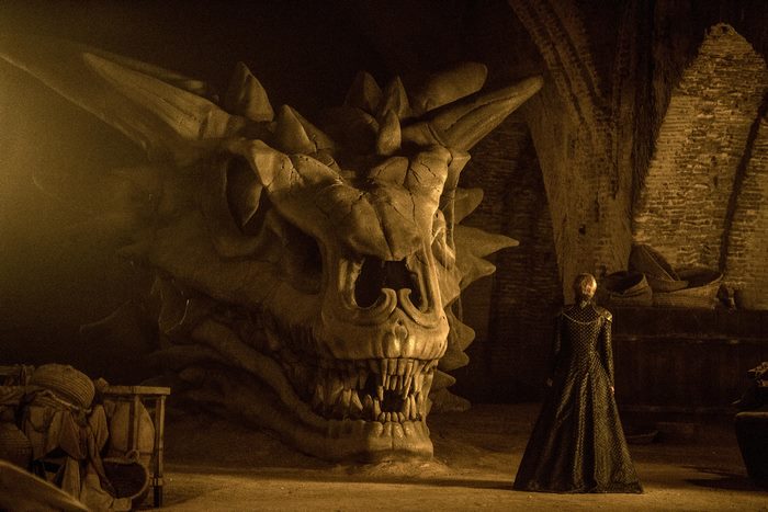 Cersei Lannister in front of a dragon skull