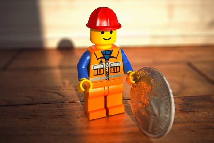 Emmet from The Lego Movie with a coin