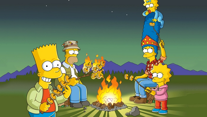 The Simpsons family roasting marshmallows by a campfire
